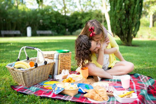 Mother and daughter having a brightly colored picnic