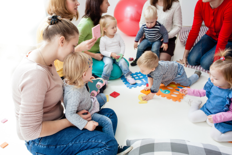 group of parents and babies and toddlers playing