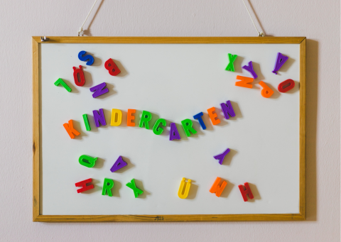 whiteboard with magnetic letters spelling out kindergarten