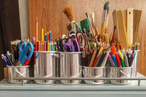 craft and school supplies arranged in various containers