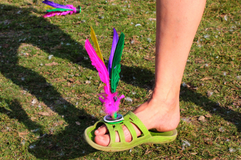 jianzi (colorful shuttlecock style toy) balanced on someone's foot