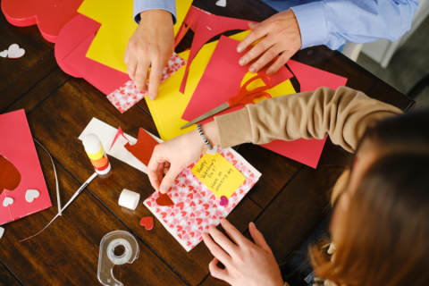 Hands making cards